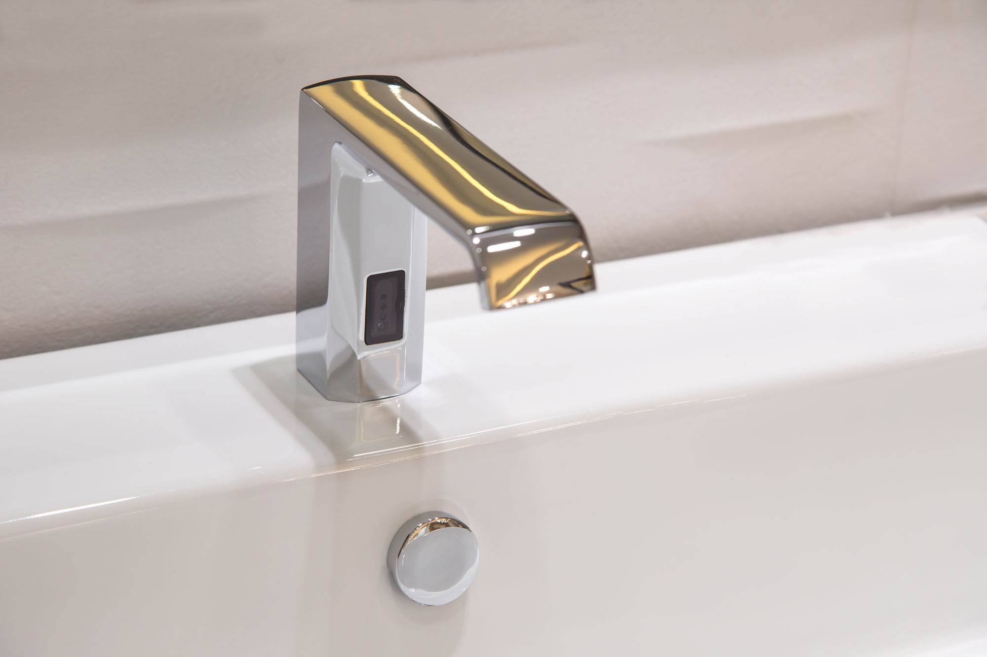 A touchless smart faucet inside a luxury bathroom
